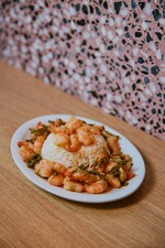 In her ‘Dragon Well Tea Shrimp’, Chef May Chow masterfully blends the earthy elegance of tea leaves with the delicate sweetness of shrimp, reimagining a timeless classic.